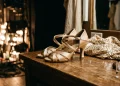 Professional ballroom dance shoes and a sequined costume on a dressing table.