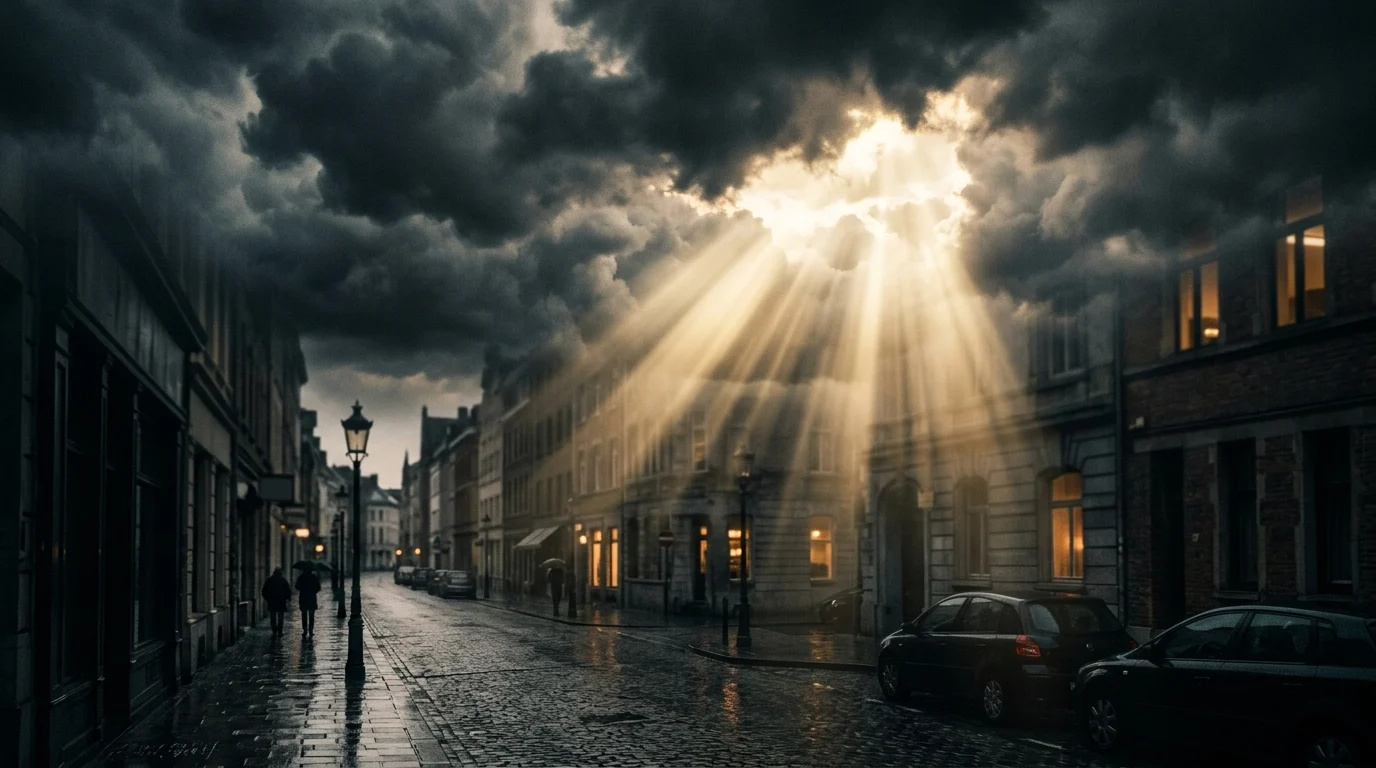 Beams of light shining through clouds onto a street.