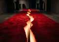 A conceptual image of a red carpet split down the middle representing a anonymous silhouettes breakup.