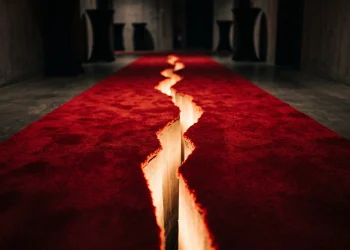 A conceptual image of a red carpet split down the middle representing a anonymous silhouettes breakup.