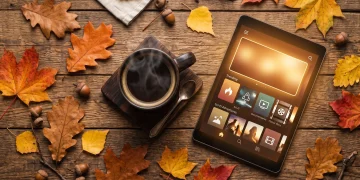 A cozy autumn setup with coffee and a tablet representing fall streaming content.