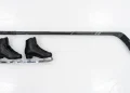 Figure skates and a hockey stick on ice representing the series .