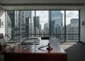 A conceptual depiction of a damaged luxury law office with city lights in the background.