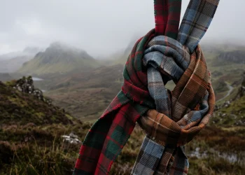 Conceptual image of intertwined tartan ribbons in the Scottish highlands.