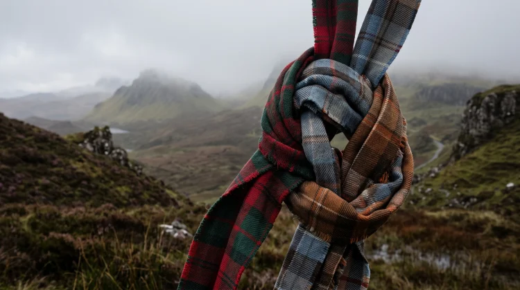 Conceptual image of intertwined tartan ribbons in the Scottish highlands.
