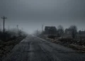 A conceptual image of a fog-covered road leading into a mysterious town.