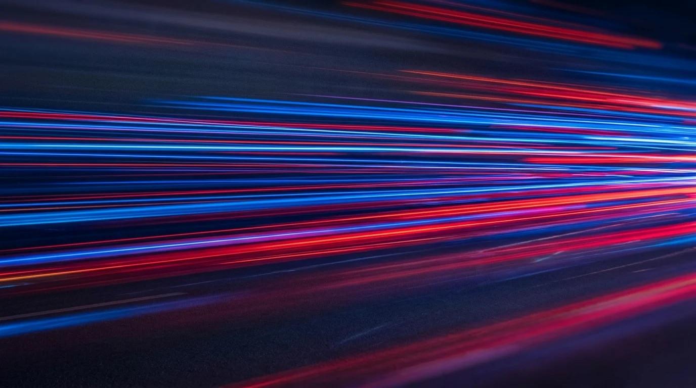 Abstract light trails suggesting speed.