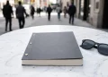 A film script for and sunglasses on a table.