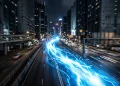 A conceptual blue streak of light racing through a dark city street representing superhero speed.