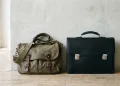 A leather diplomat briefcase and a 90s style messenger bag side-by-side.