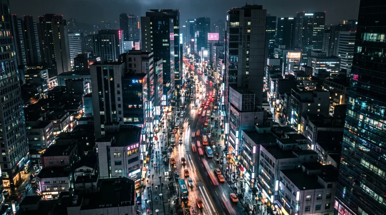 A cinematic conceptual view of a neon-lit urban street at night representing a modern city.