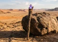 A wooden wizard staff in a desert setting.
